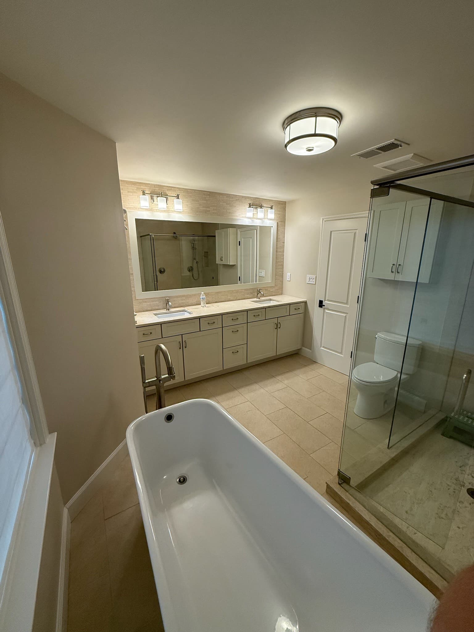 Powder room with hand-troweled plaster and antique mirror