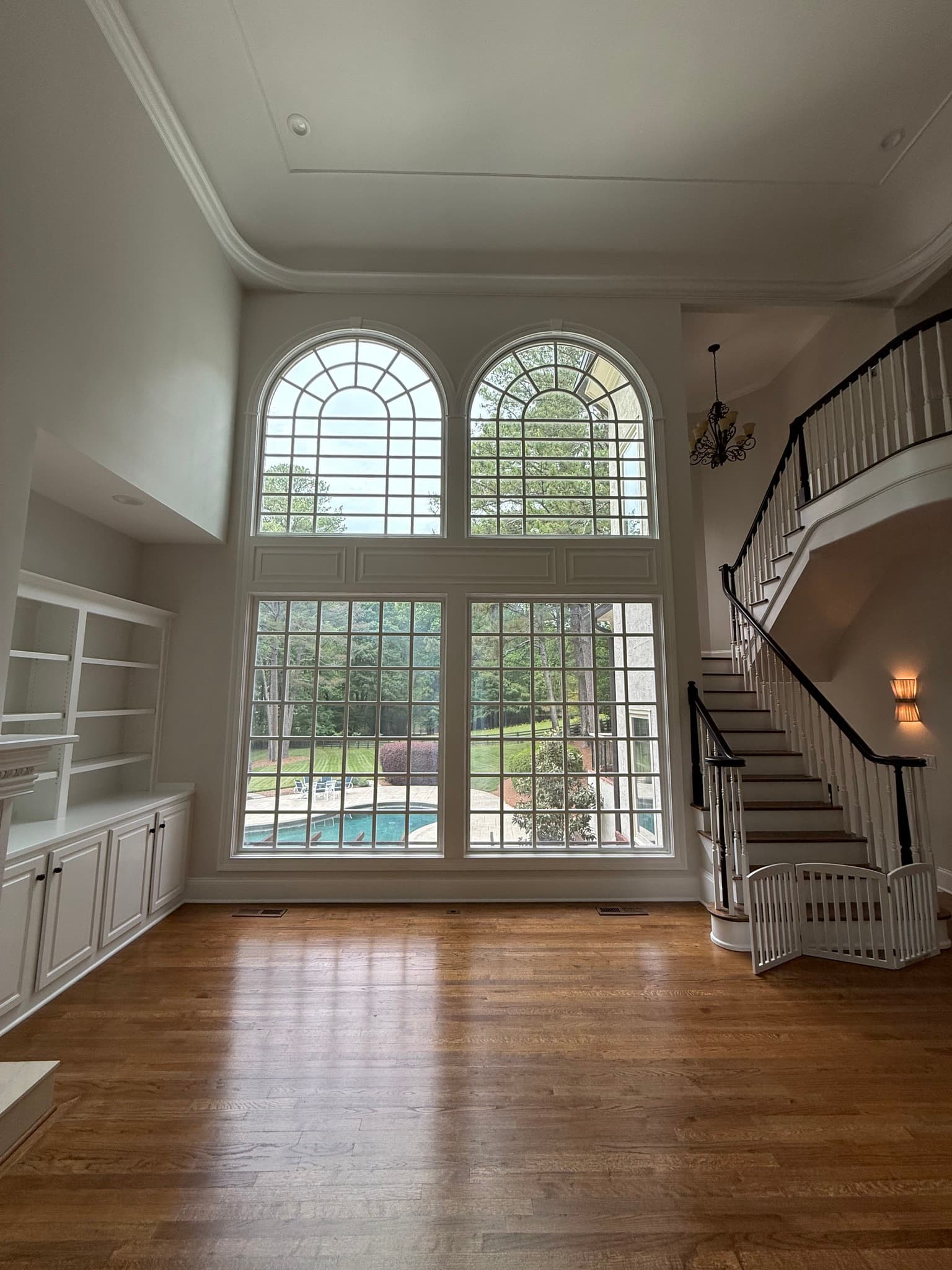 Two-story foyer with arched windows and a curved staircase